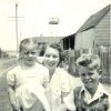 Margaret Slowgrove with family outside home, Botany 1952